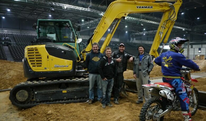 Kompaktbagger baut Indoor-Motocross-Strecke